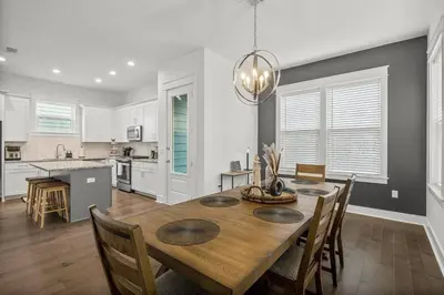 a kitchen and dining room with a table and chairs at Special ! Free Golf Cart ! Spring Paradise! in Panama City Beach