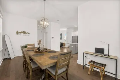 a kitchen and dining room with a wooden table and chairs at Special ! Free Golf Cart ! Spring Paradise! in Panama City Beach