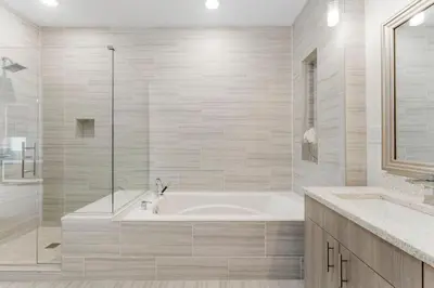 a white bathroom with a tub and a shower at The Pointe Unit 326 by 30A Escapes in Rosemary Beach