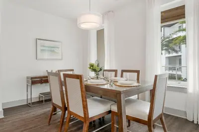 a dining room with a wooden table and chairs at The Pointe Unit 326 by 30A Escapes in Rosemary Beach