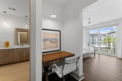 a bedroom with a desk and a bedroom with a bed at Texas Two Step by 30A Escapes in Rosemary Beach
