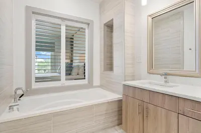 a bathroom with a tub and a sink and a window at The Pointe Unit 342 by 30A Escapes in Rosemary Beach