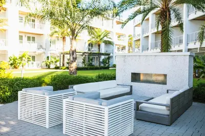 a patio with a fireplace in front of a building at The Pointe Unit 342 by 30A Escapes in Rosemary Beach