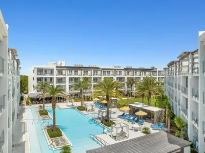 an aerial view of a hotel with a pool and palm trees at The Pointe Unit 342 by 30A Escapes in Rosemary Beach