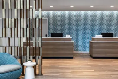 a lobby with desks and a blue and white patterned wall at Residence Inn Panama City Beach Pier Park in Panama City Beach