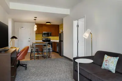 a living room with a couch and a kitchen at Residence Inn Panama City Beach Pier Park in Panama City Beach