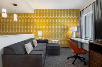 a living room with a couch and a desk at Residence Inn Panama City Beach Pier Park in Panama City Beach