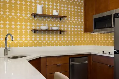 a kitchen with white countertops and yellow wallpaper at Residence Inn Panama City Beach Pier Park in Panama City Beach