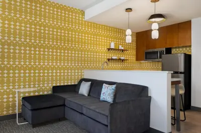 a living room with a couch and a kitchen at Residence Inn Panama City Beach Pier Park in Panama City Beach