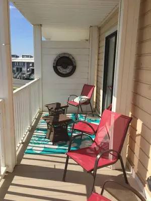 two chairs and a table on a porch at Beach Place Seconds to Beach 23 in Panama City Beach