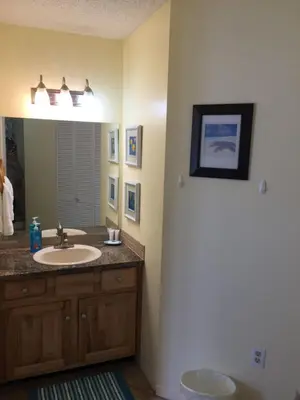 a bathroom with a sink and a mirror at Beach Place Seconds to Beach 23 in Panama City Beach
