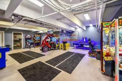 a childrens room with a game room with a arcade at Emerald Beach #1236 by Book That Condo in Panama City Beach