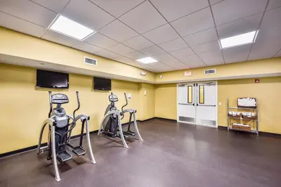 a gym with two exercise bikes and a flat screen tv at Emerald Beach #1236 by Book That Condo in Panama City Beach