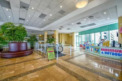 a lobby with a restaurant with a food counter at Emerald Beach #1236 by Book That Condo in Panama City Beach