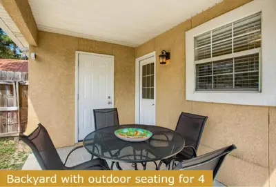 a patio table with outdoor seating for at Estrella del Mar in Panama City Beach
