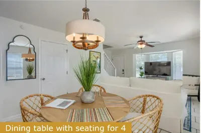 a dining table with seating for four in a living room at Estrella del Mar in Panama City Beach