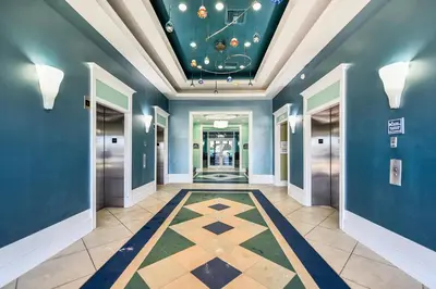 a hallway with blue walls and a ceiling with a tile floor at Boardwalk Beach Resort #1206 by Book That Condo in Panama City Beach