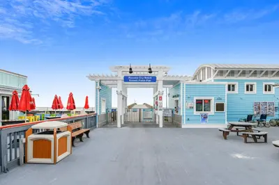 a large deck with benches and a blue building at Boardwalk Beach Resort #1206 by Book That Condo in Panama City Beach