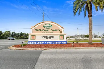 a sign for a regional center with a palm tree at Boardwalk Beach Resort #1206 by Book That Condo in Panama City Beach