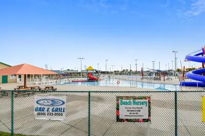 a view of an empty water park behind a fence at Boardwalk Beach Resort #1206 by Book That Condo in Panama City Beach
