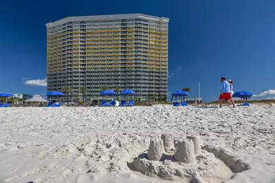 a sand castle on the beach with a building in the background at Boardwalk Beach Resort #1206 by Book That Condo in Panama City Beach
