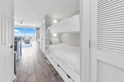 a bedroom with a bunk bed and a balcony at Boardwalk 2005 in Panama City Beach