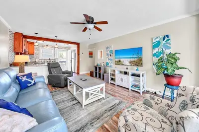a living room with a couch and a table at Misty Harbour 7 in Panama City Beach