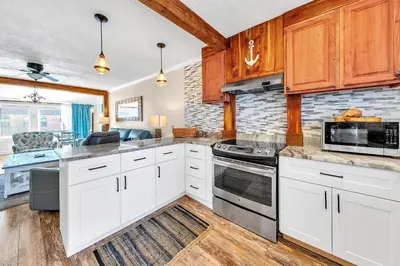 a kitchen with white cabinets and a stove top oven at Misty Harbour 7 in Panama City Beach
