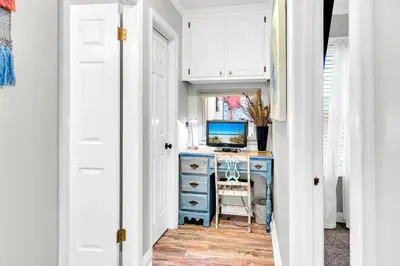 a hallway with a desk with a computer on it at Misty Harbour 7 in Panama City Beach