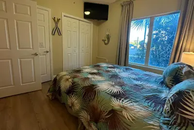 a bedroom with a bed and a large window at Tidewater 100 in Panama City Beach