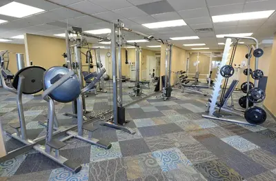 a gym with a bunch of equipment in a room at Tidewater 100 in Panama City Beach