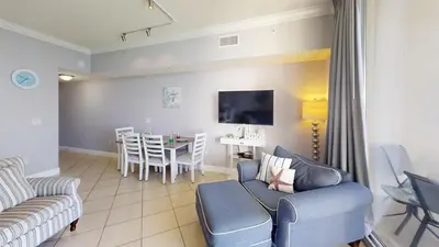 a living room with a couch and a table at Tidewater 2714 in Panama City Beach