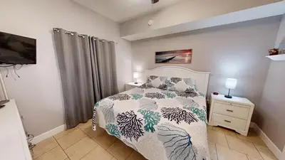 a bedroom with a bed and a television in it at Tidewater 2714 in Panama City Beach
