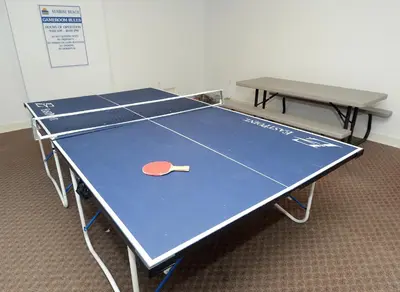 a ping pong table with a tennis racket on it at Sunrise Beach 1001 in Panama City Beach