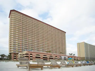 a large building with benches in front of a beach at Sunrise Beach 1001 in Panama City Beach