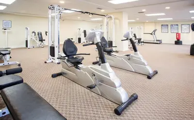 a gym with treadmills and elliptical machines at Sunrise Beach 1001 in Panama City Beach