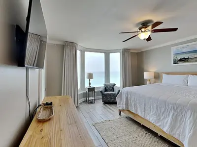 a bedroom with a bed and a ceiling fan at Emerald Beach #830 in Panama City Beach