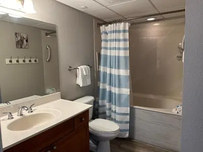 a bathroom with a sink and a toilet and a shower at Emerald Beach #830 in Panama City Beach