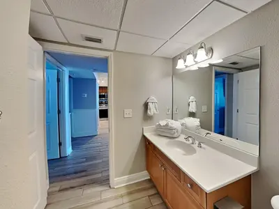 a bathroom with a sink and a mirror at Emerald Beach #830 in Panama City Beach