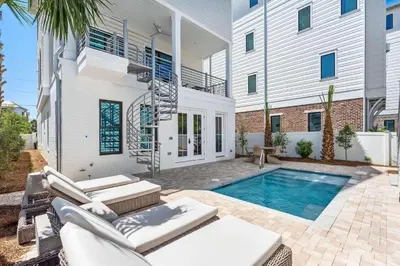 a villa with a swimming pool and a house at 30A Sunset in Santa Rosa Beach