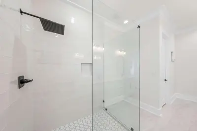 a shower with a glass door in a bathroom at 30A Sunset in Santa Rosa Beach