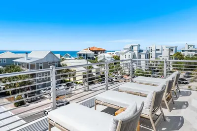 a balcony with chairs and a view of the ocean at 30A Sunrise in Santa Rosa Beach