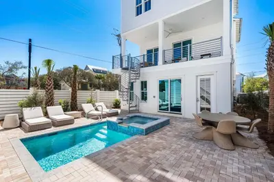 a villa with a swimming pool and a house at 30A Sunrise in Santa Rosa Beach