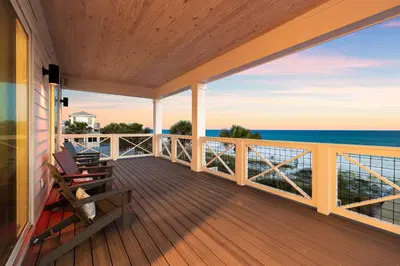 a balcony with chairs and the ocean view at Jewel of Oleander by 30A Escapes in Panama City Beach