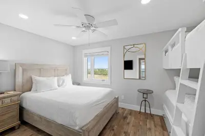 a bedroom with a bed with a ceiling fan at Ramsgate Harbour #5 by 30A Escapes in Panama City Beach