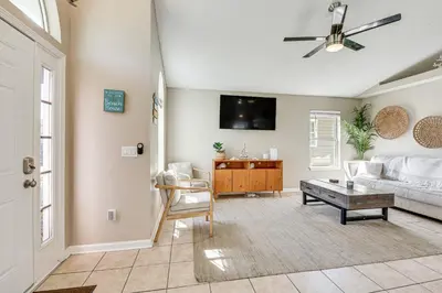 a living room with a couch and a tv at Charming PCB Home about 1 Mi to Beach Access! in Panama City Beach