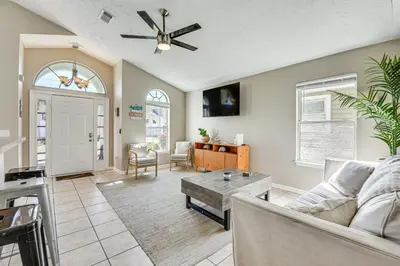 a living room with a couch and a table at Charming PCB Home about 1 Mi to Beach Access! in Panama City Beach