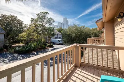 a balcony of a house with a view of a street at Somewhere in the Sun in Santa Rosa Beach