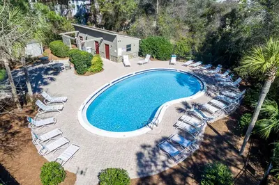 an overhead view of a swimming pool with lounge chairs at Somewhere in the Sun in Santa Rosa Beach