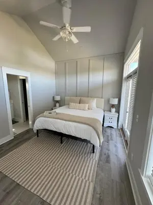 a bedroom with a bed and a ceiling fan at Barefoot Dreams! in Panama City Beach